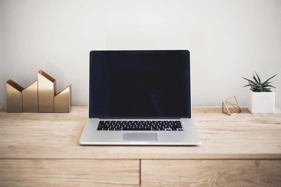 Laptop and notebook on a desk representing an affiliate marketing beginner's workspace